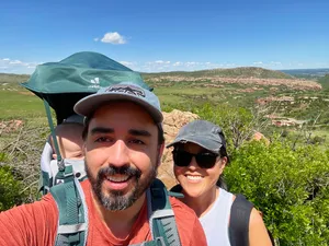 Andrew, Theresa, and baby obscured in a hiking carrier in the foothills