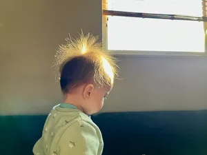 The sun shining through the staticky hair of a toddler