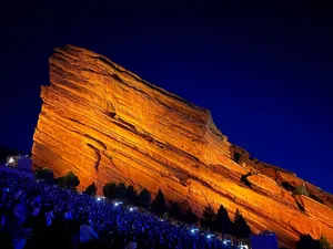 Lit up rock slab at Red Rocks Amphitheatre under a dark blue night sky