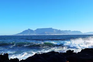 Waves crashing on the island across from Cape Town andTable Mountain